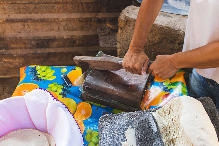 Woman making tortillas by hand Centenario 107